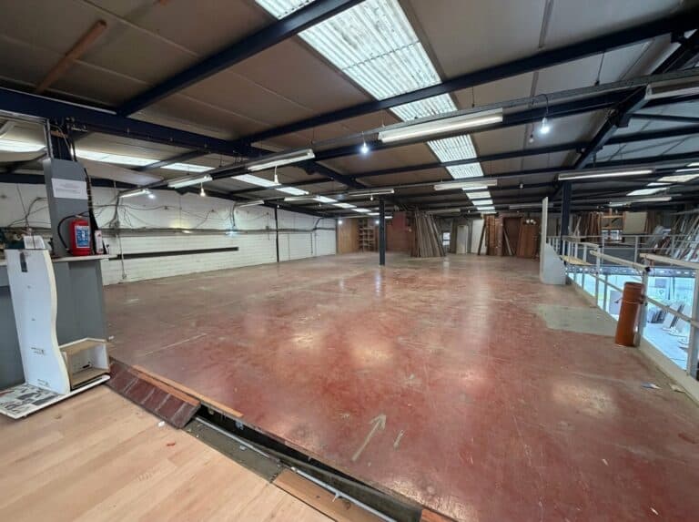 An empty warehouse with the floor removed and an open structure.